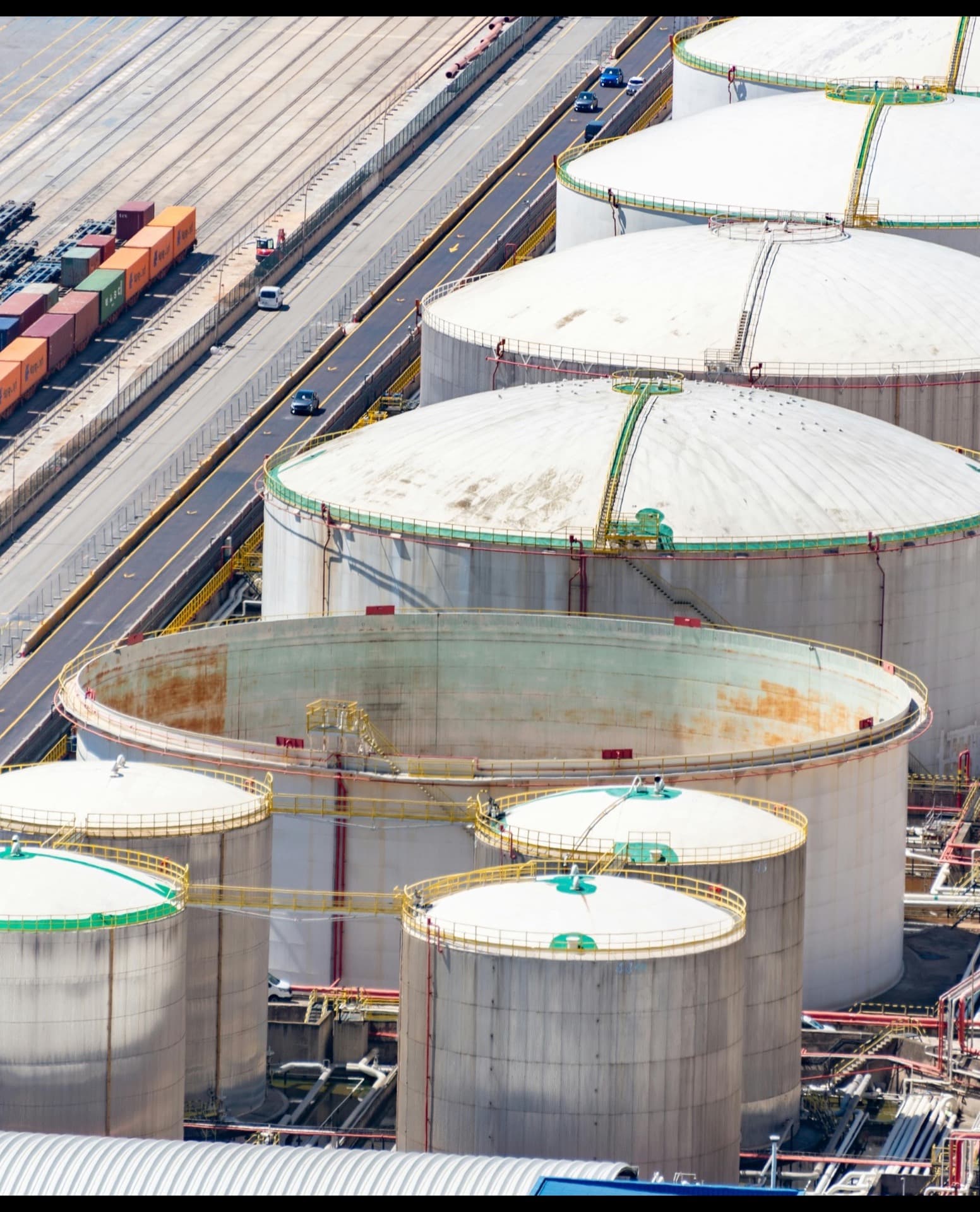 Aerial view of a tank farm at sunset showing storage and process units