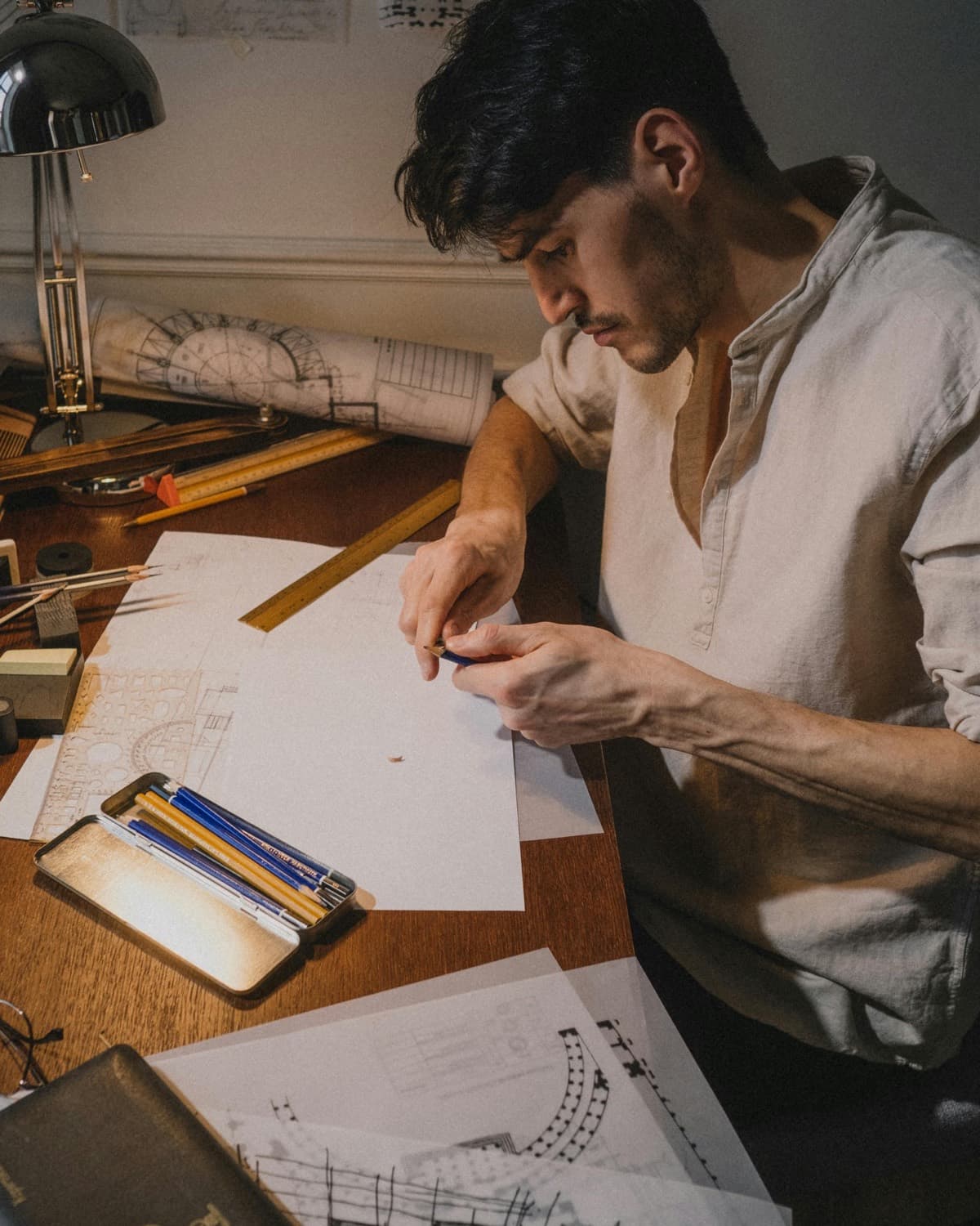 Engineer at a desk studying technical drawings and project documentation
